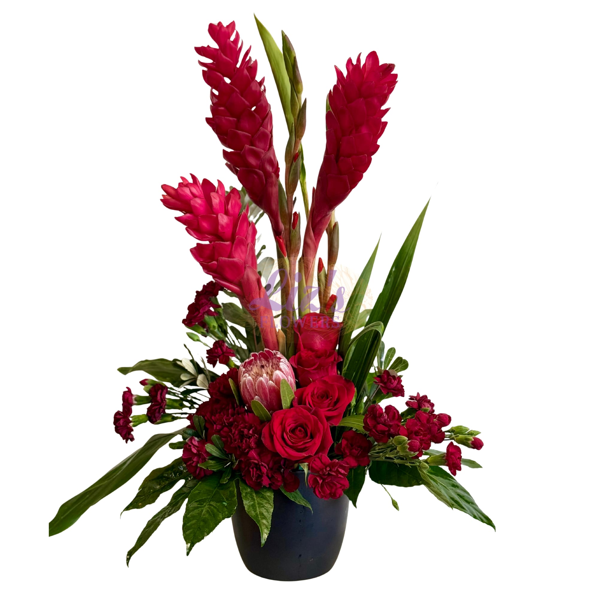 Red tropical flowers arranged in a black pot with roses and greenery