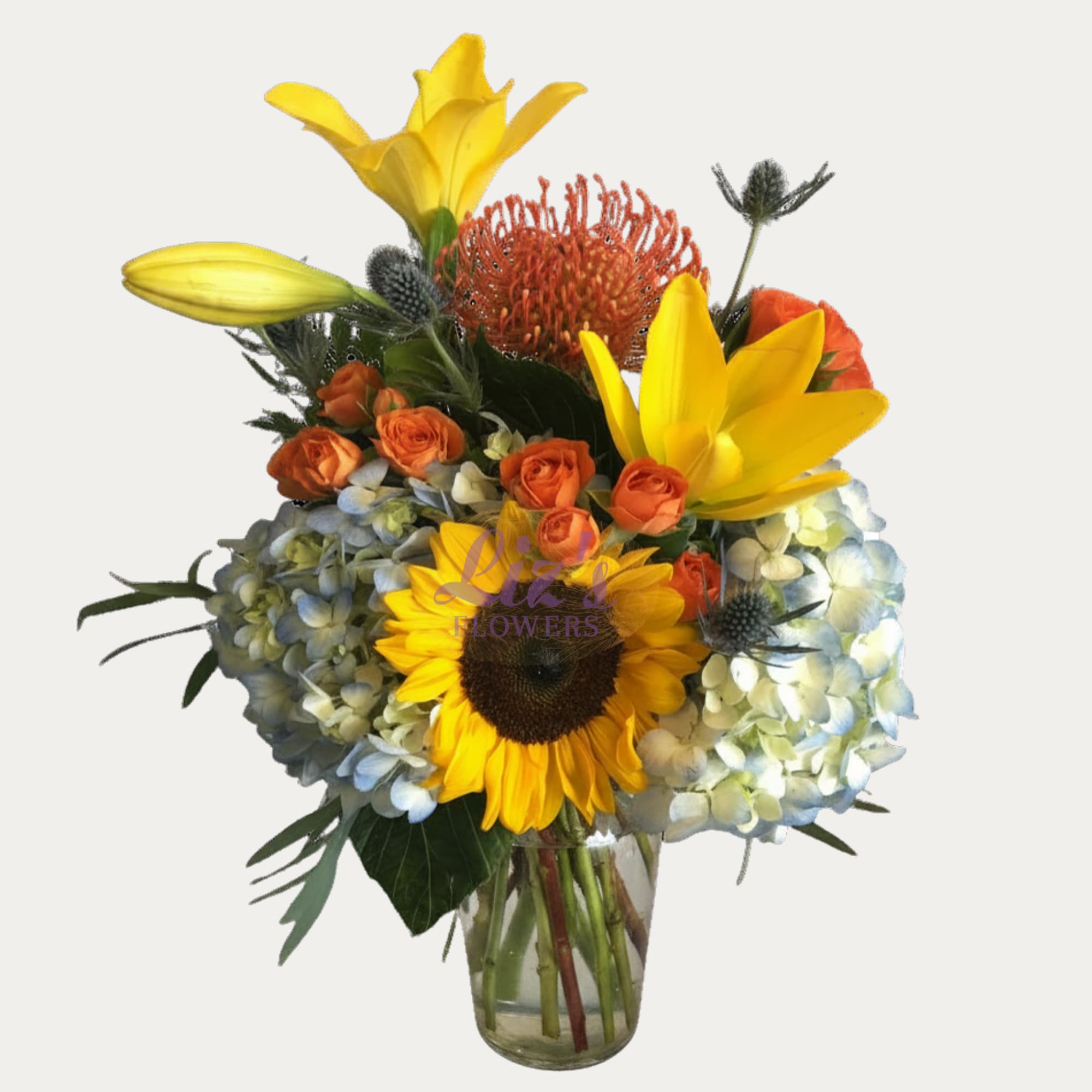 Sunshine Arrangement  - Mixed of sunflowers, lilies, hydrangeas, spray roses, and protea. 