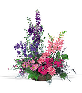 Tall mixed bouquet of purple and pink flowers in a low container