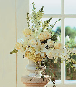 Cream and white floral arrangement in a white vase