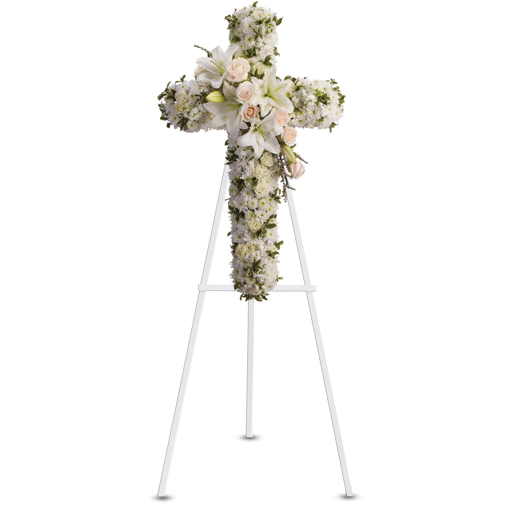 Standing cross of white flowers with pale roses and lilies on a white easel stand