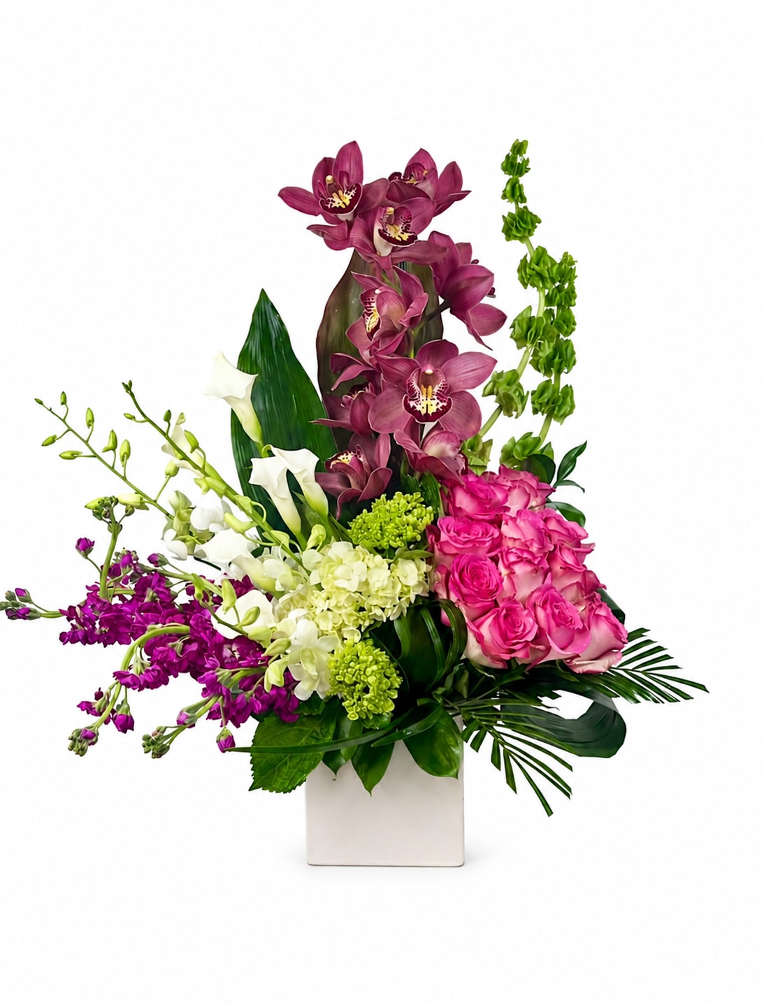 Amore  - A sophisticated arrangement featuring rich burgundy orchids, vibrant pink roses, graceful white calla lilies and dendrobium orchids, accented with lush green blooms and tropical foliage. Designed in a modern white vase, this striking composition offers a perfect balance of elegance, color, and contemporary style for any special occasion.
