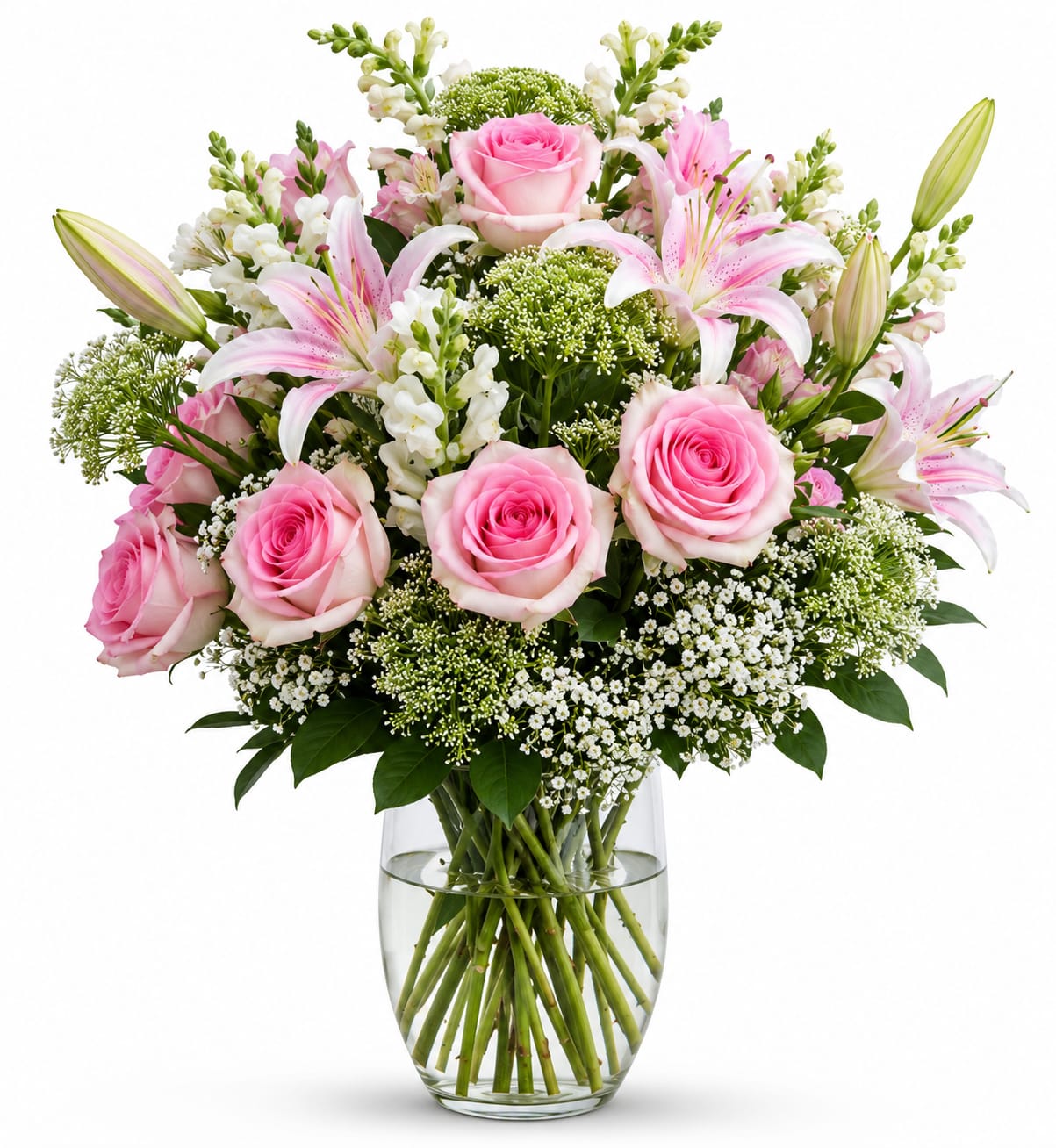 Floral Fantasy  - Soft, elegant, and timeless, this beautiful bouquet features delicate pink roses, fragrant pink lilies, and fresh white accent blooms arranged with lush greenery in a clear glass vase. Perfect for birthdays, anniversaries, new babies, or simply letting someone know you care, this graceful arrangement brings beauty and warmth to any occasion.