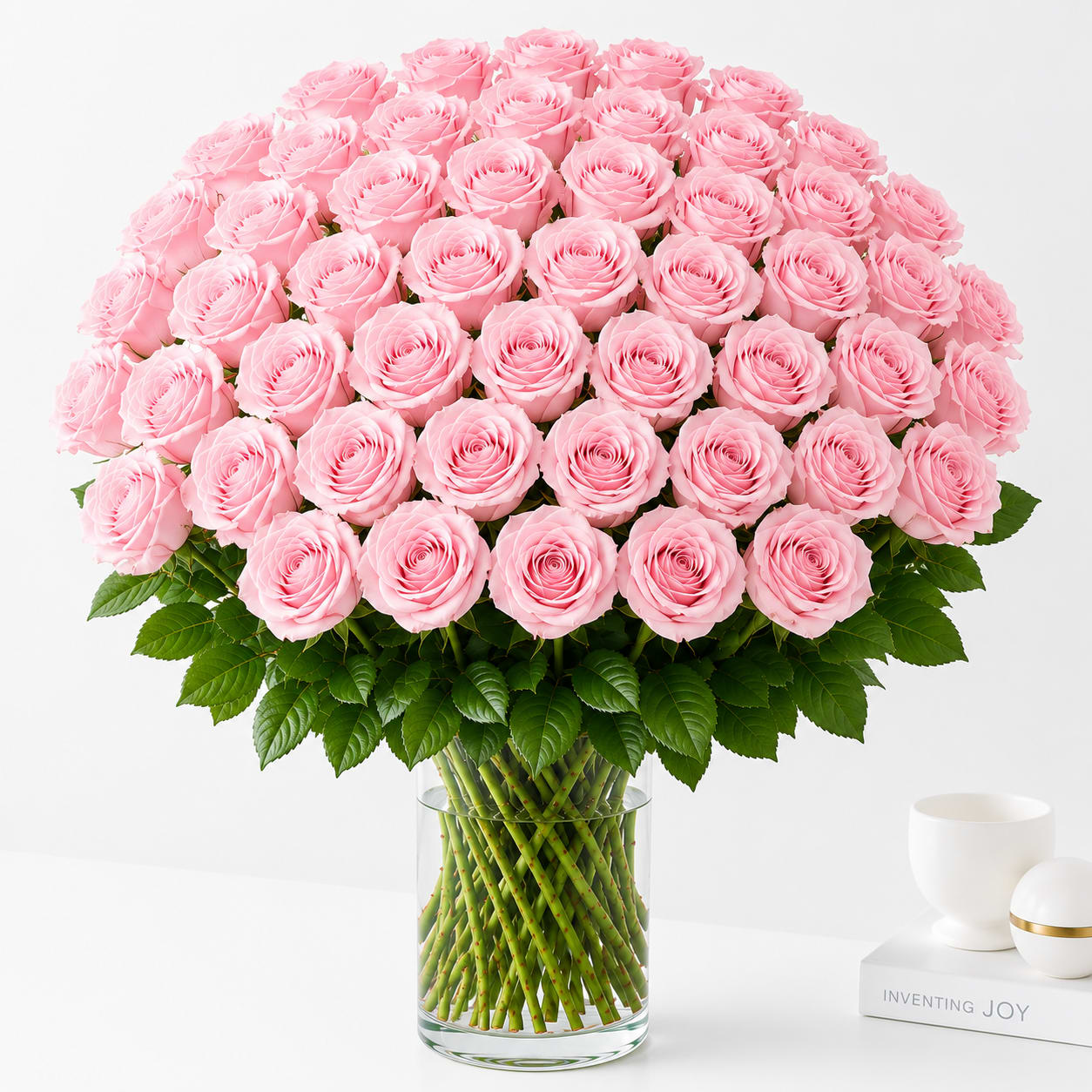 48 Light Pink Roses  - Make an unforgettable statement with this breathtaking bouquet of 36 premium long-stem light pink roses. Expertly arranged in a clear glass vase with lush greenery, this timeless design is the perfect expression of love, romance, admiration, or celebration. Ideal for anniversaries, birthdays, Valentine's Day, or any occasion that deserves a grand gesture.