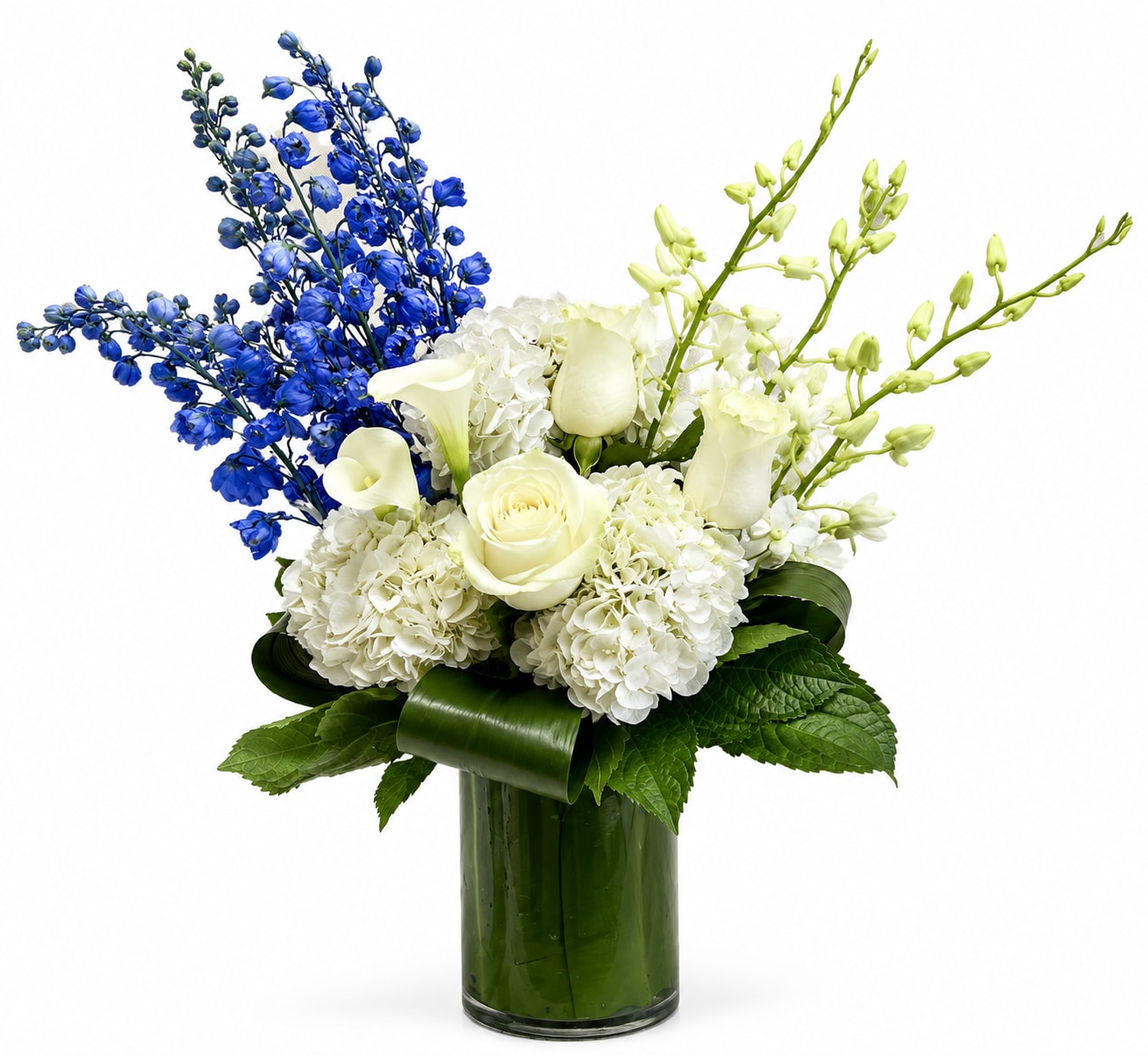 White roses and hydrangeas with blue and green orchids in a glass vase