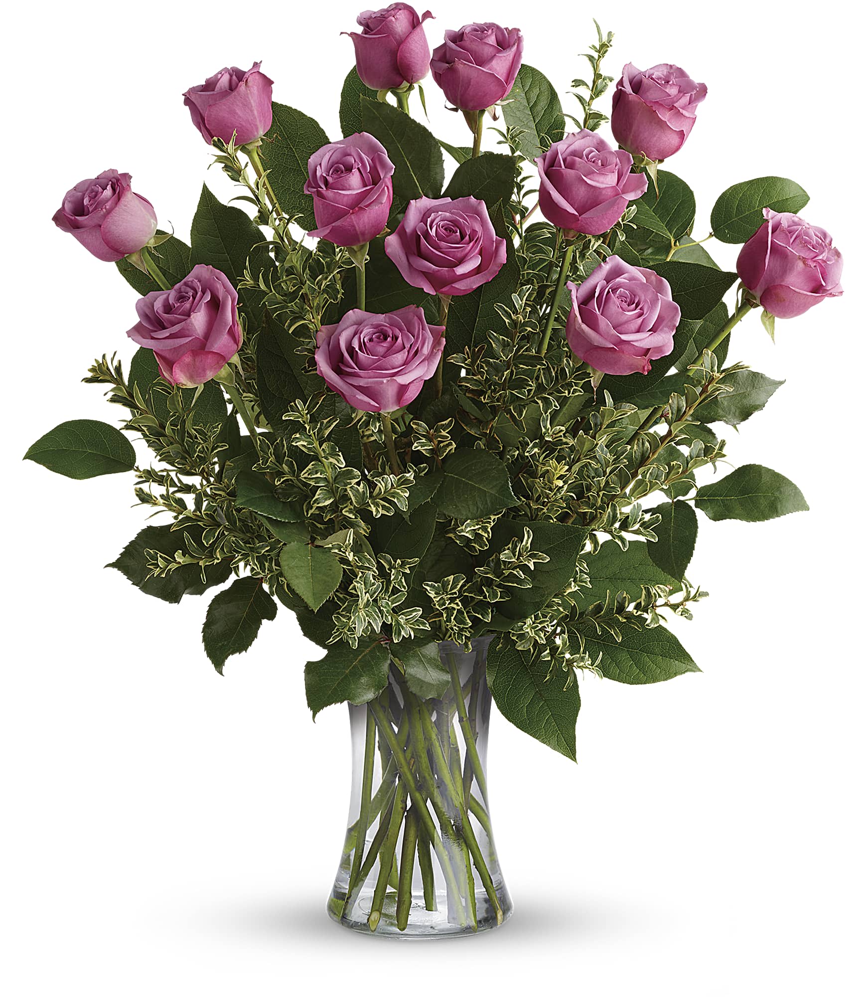 Pink roses arranged in a clear glass vase with mixed greenery