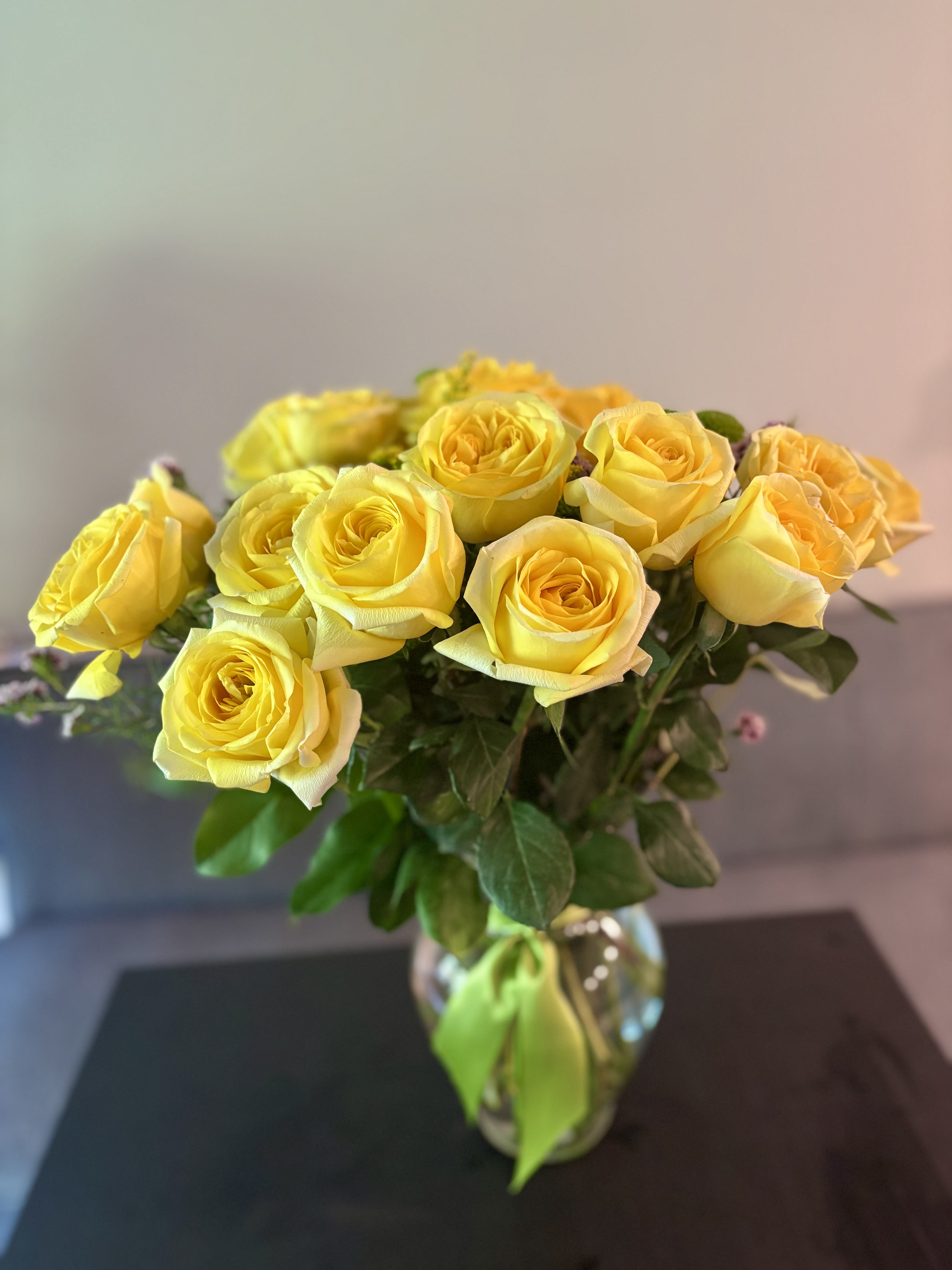 Yellow roses arranged in a clear glass vase