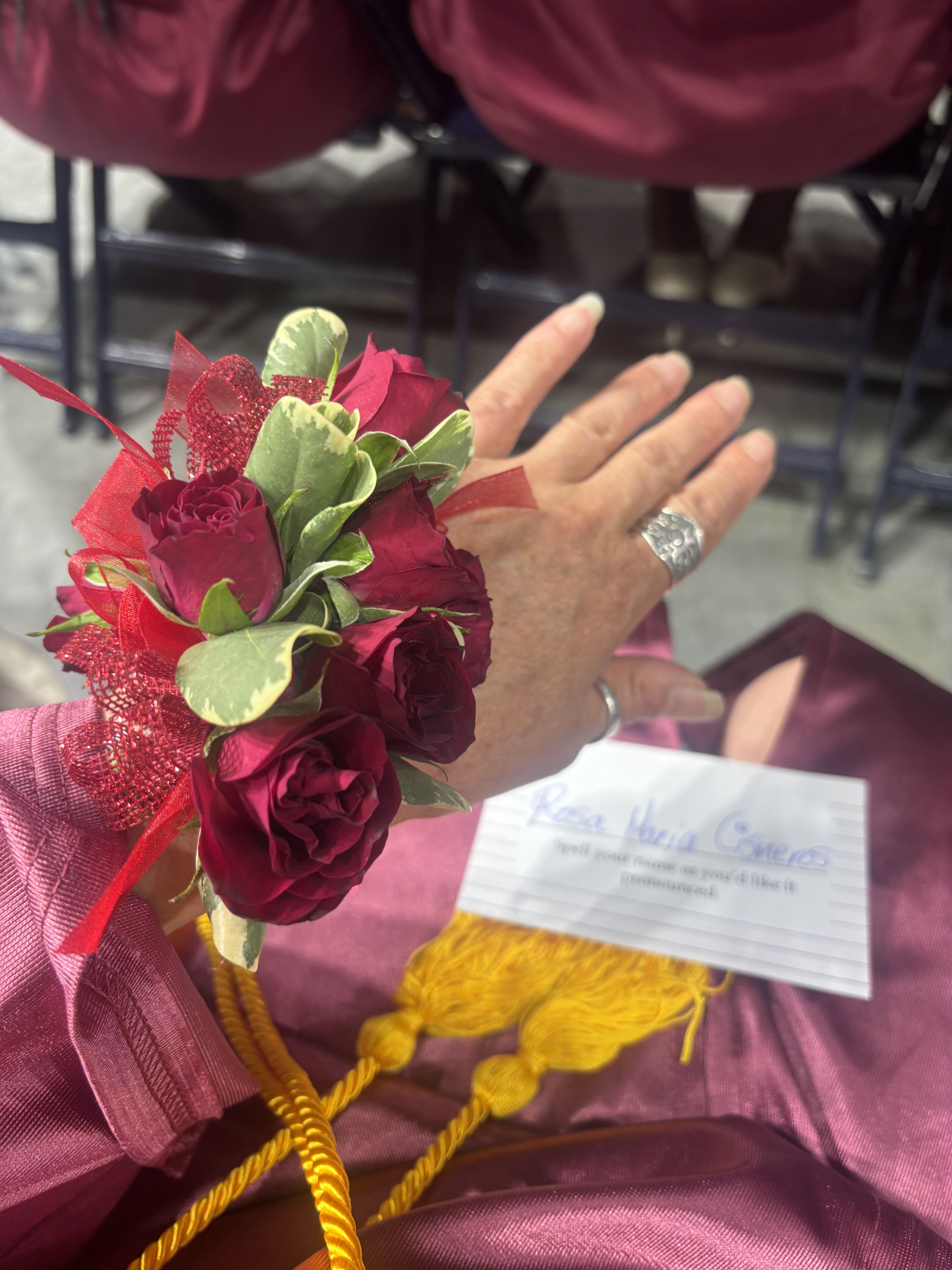 Small wrist corsage with deep red roses and ribbon