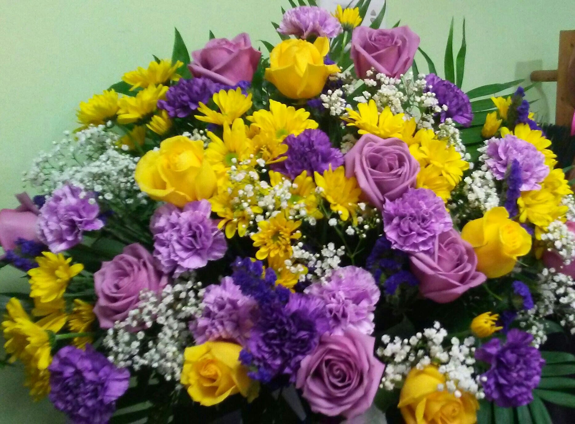 Bouquet of yellow and purple flowers with lavender roses