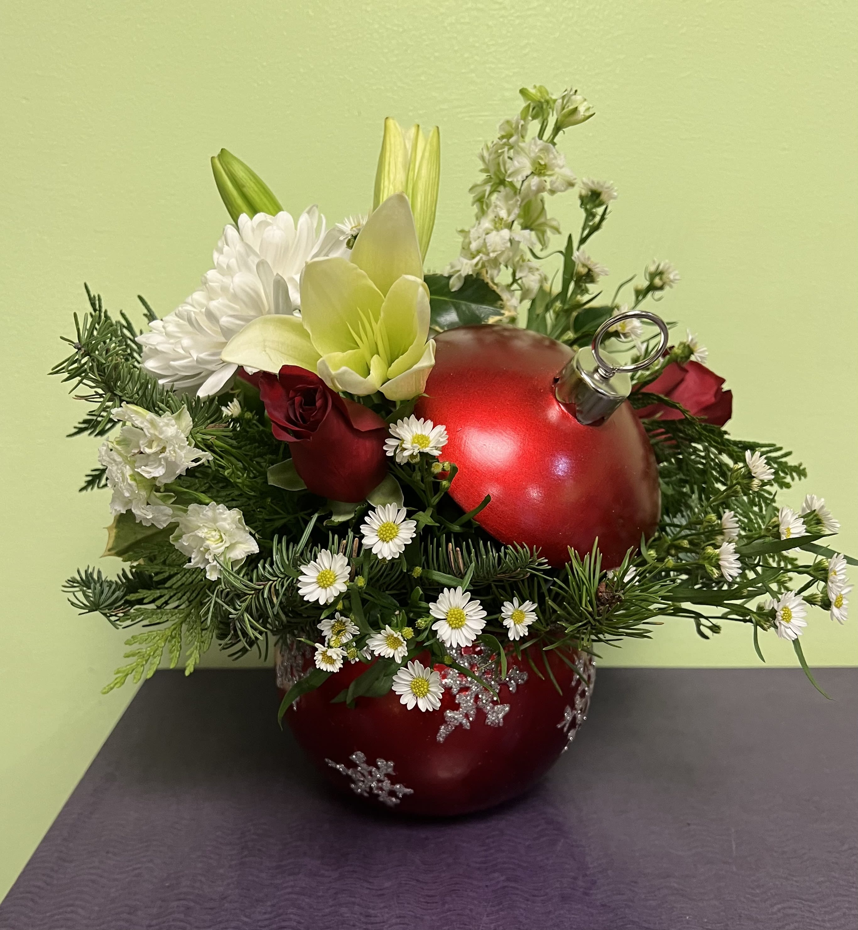 Red ornament vase arrangement with white flowers and greenery