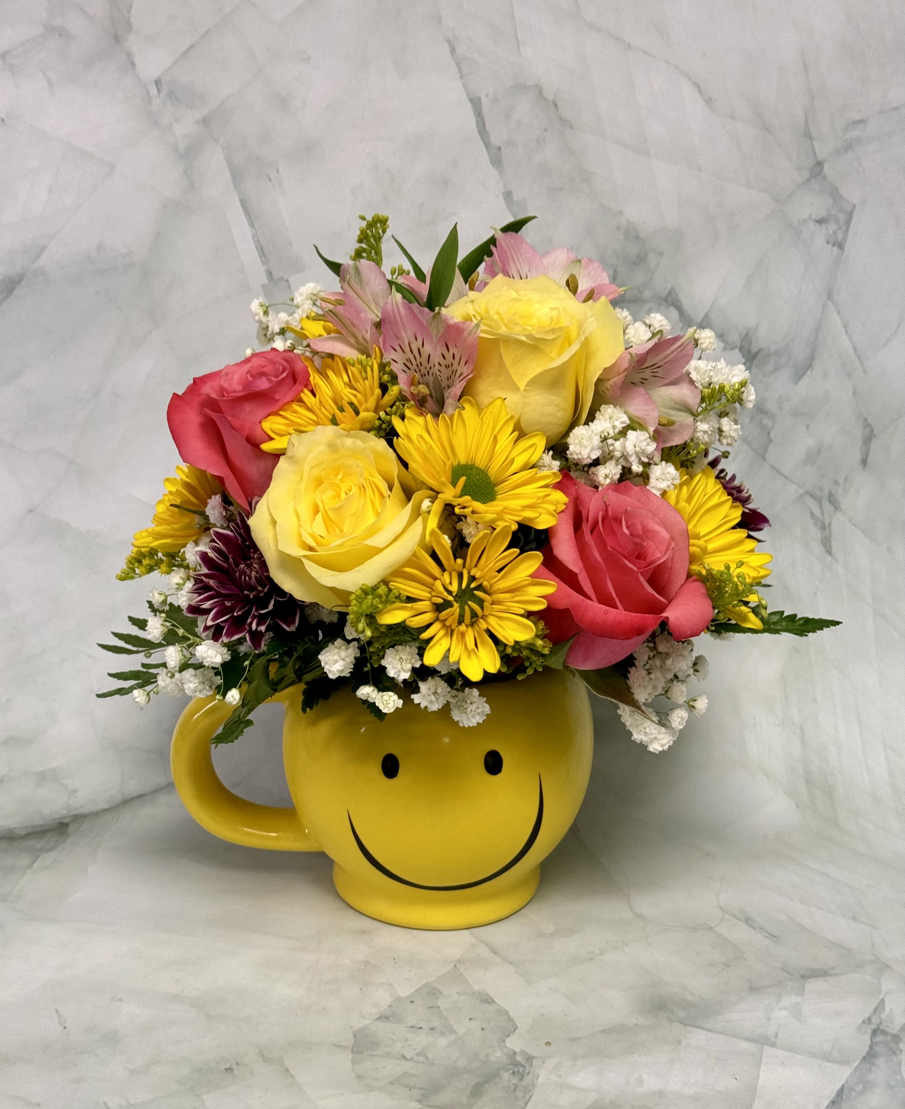 Mixed bouquet in a yellow smiley-face mug