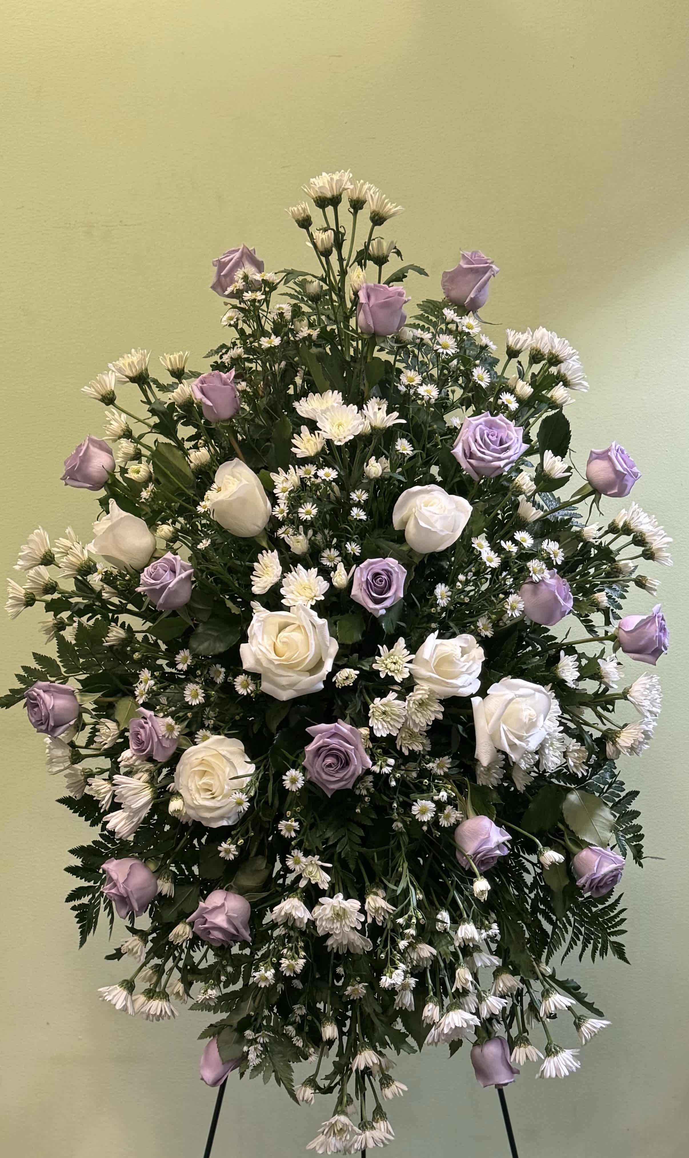 Standing floral spray with lavender and white roses and small white daisies
