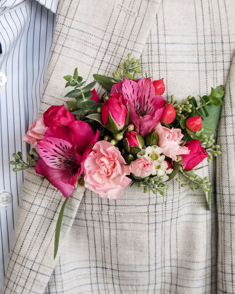 Pink and red floral corsage with roses and alstroemeria