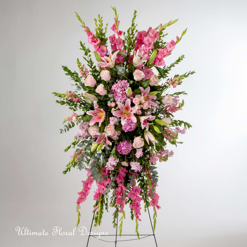 Tall pink floral standing spray with lilies and roses on an easel