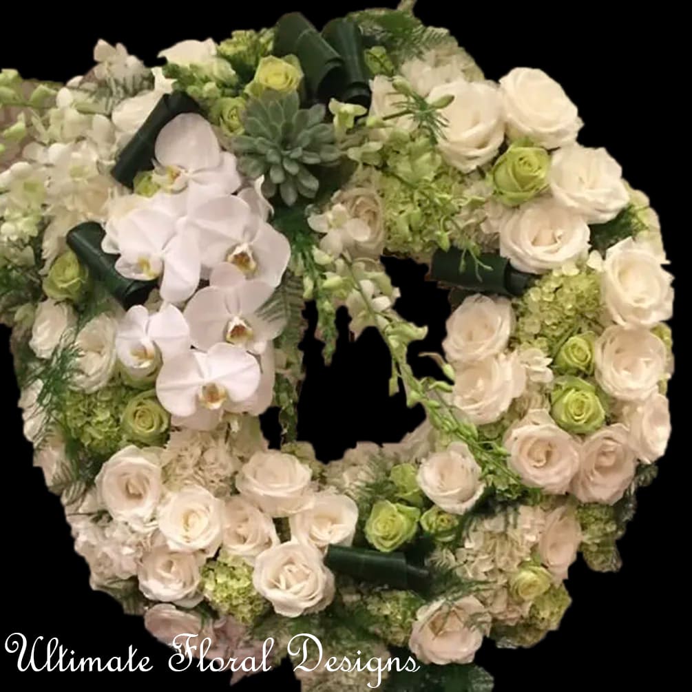 Heart-shaped floral wreath with white roses and orchids