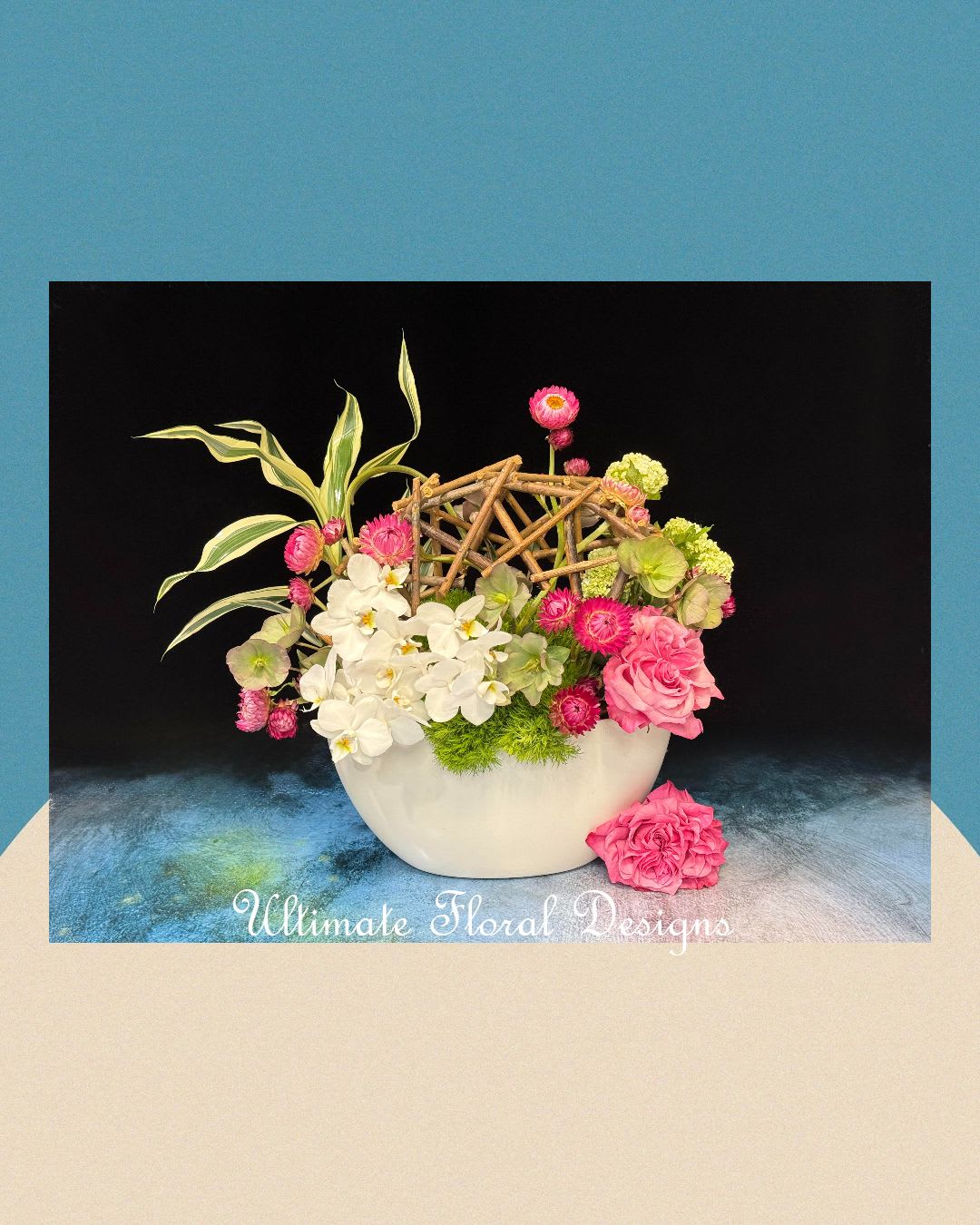 Pink and white floral arrangement in a white bowl with a twig lattice accent