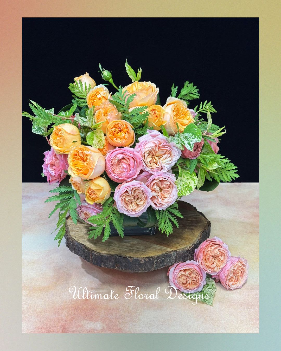 Bouquet of peach and pink roses arranged in a low vase