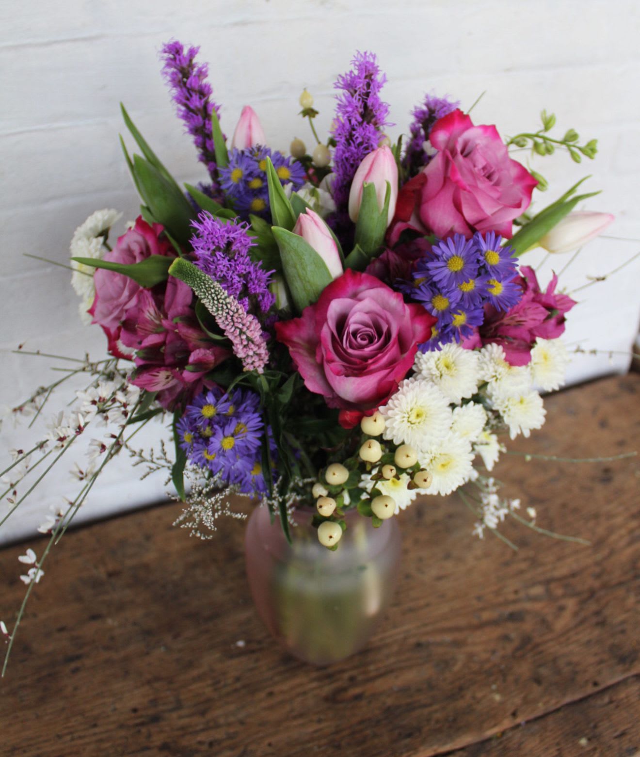 Sugar, Spice &amp; Everything Purple - Beautiful varieties of roses, tulips and mixed farm fresh flowers.   Medium-Tall arrangement 