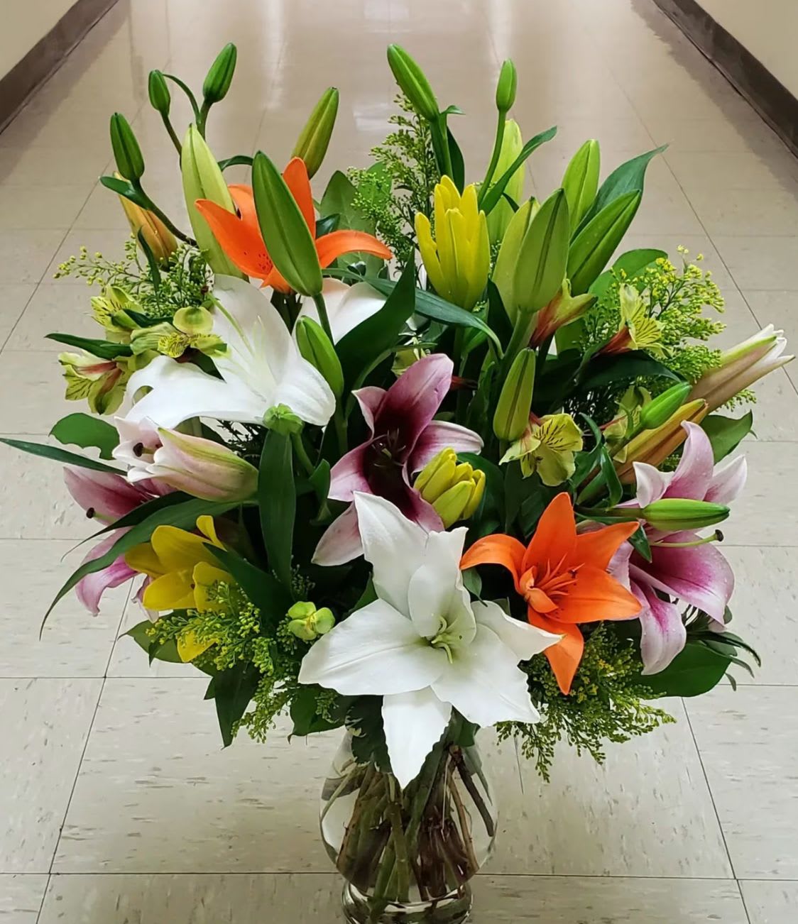 DESIGNERS CHOICE - OHH LILY - Ohh Lily is a lily-forward arrangement designed to highlight the natural beauty and variety of premium blooms.   Featuring a curated selection of mixed lilies, each design is thoughtfully composed to showcase texture, movement, and balance. With a refined, modern aesthetic and a focus on quality, Ohh Lily offers a fresh and elegant presentation—perfect for any occasion or simply elevating everyday spaces.   **often times lilies are freshly picked and will fully bloom after delivery/pick-up