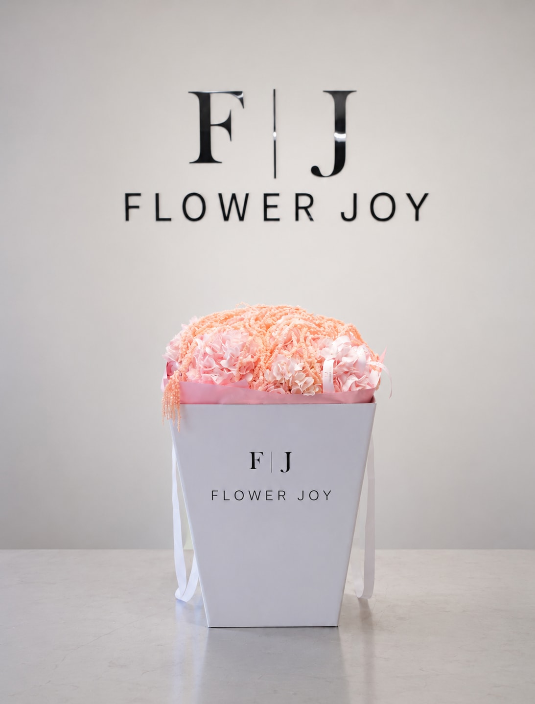 Blush Hydrangea Box - A soft arrangement of blush-pink hydrangeas accented with delicate cascading amaranthus, beautifully presented in a signature Flower Joy box. Elegant, romantic, and perfect for birthdays, baby showers, anniversaries, or thoughtful celebrations.