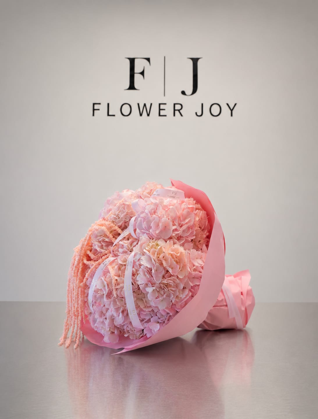Blush Hydrangea Cascade - A soft and romantic bouquet of blush-pink hydrangeas accented with delicate cascading amaranthus, elegant ribbon details, and matching pink wrapping. Graceful and charming, perfect for birthdays, anniversaries, baby showers, or heartfelt celebrations.
