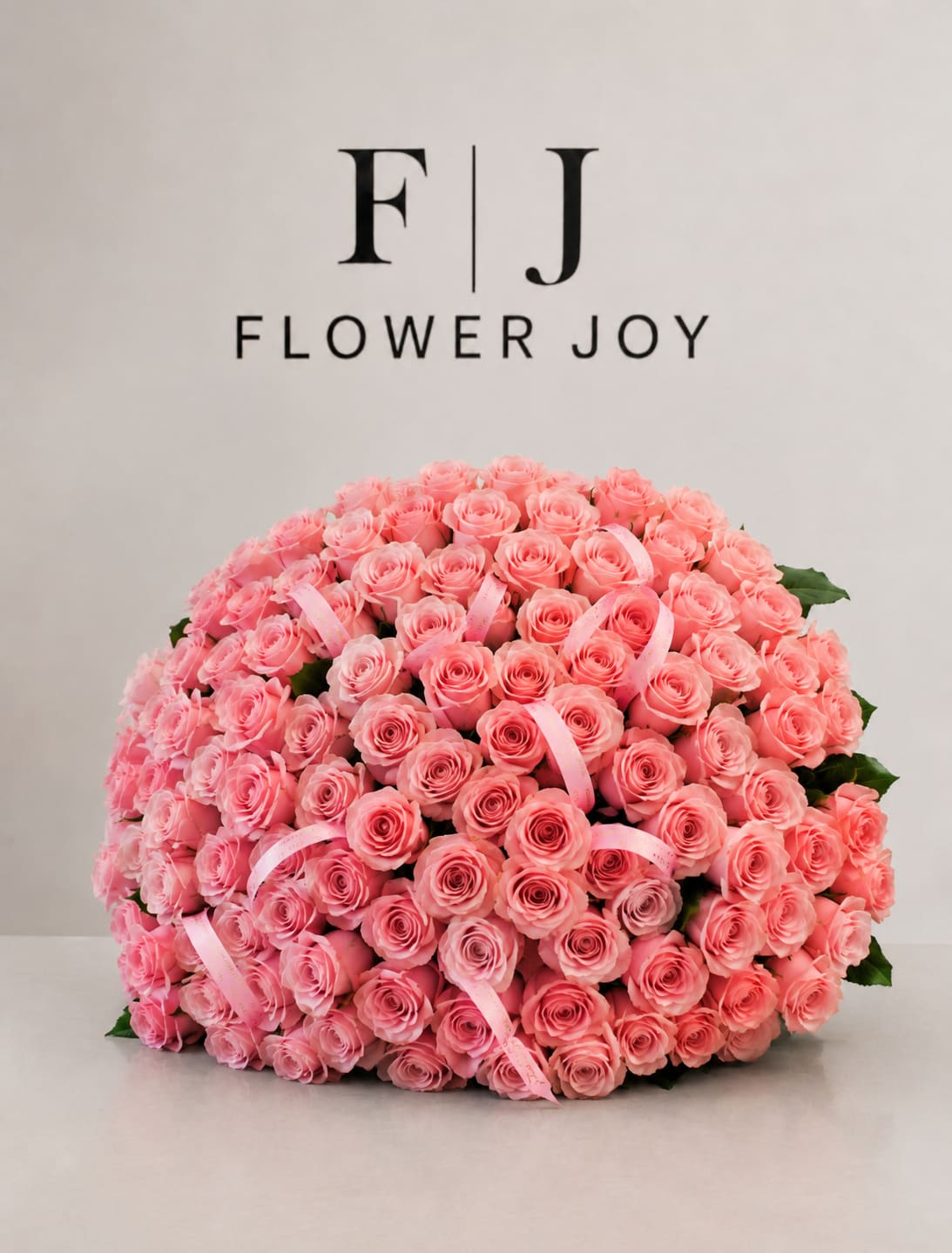Blushing Elegance Bouquet (75 Roses) - A luxurious arrangement of soft pink roses, beautifully gathered with delicate ribbon details. Romantic, graceful, and full of charm, perfect for birthdays, anniversaries, celebrations, or simply making someone feel special.