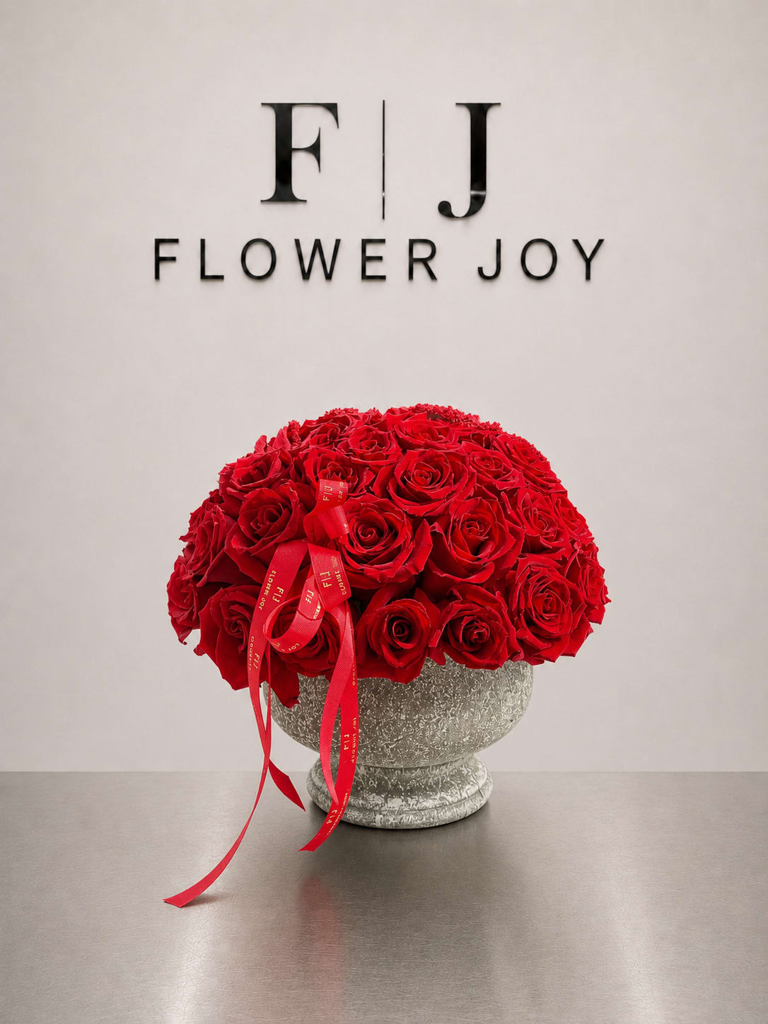 Classic Red Romance - A luxurious arrangement of deep red roses in a vintage silver vase, finished with elegant red ribbons. Perfect for anniversaries, romantic surprises, and unforgettable special moments.
