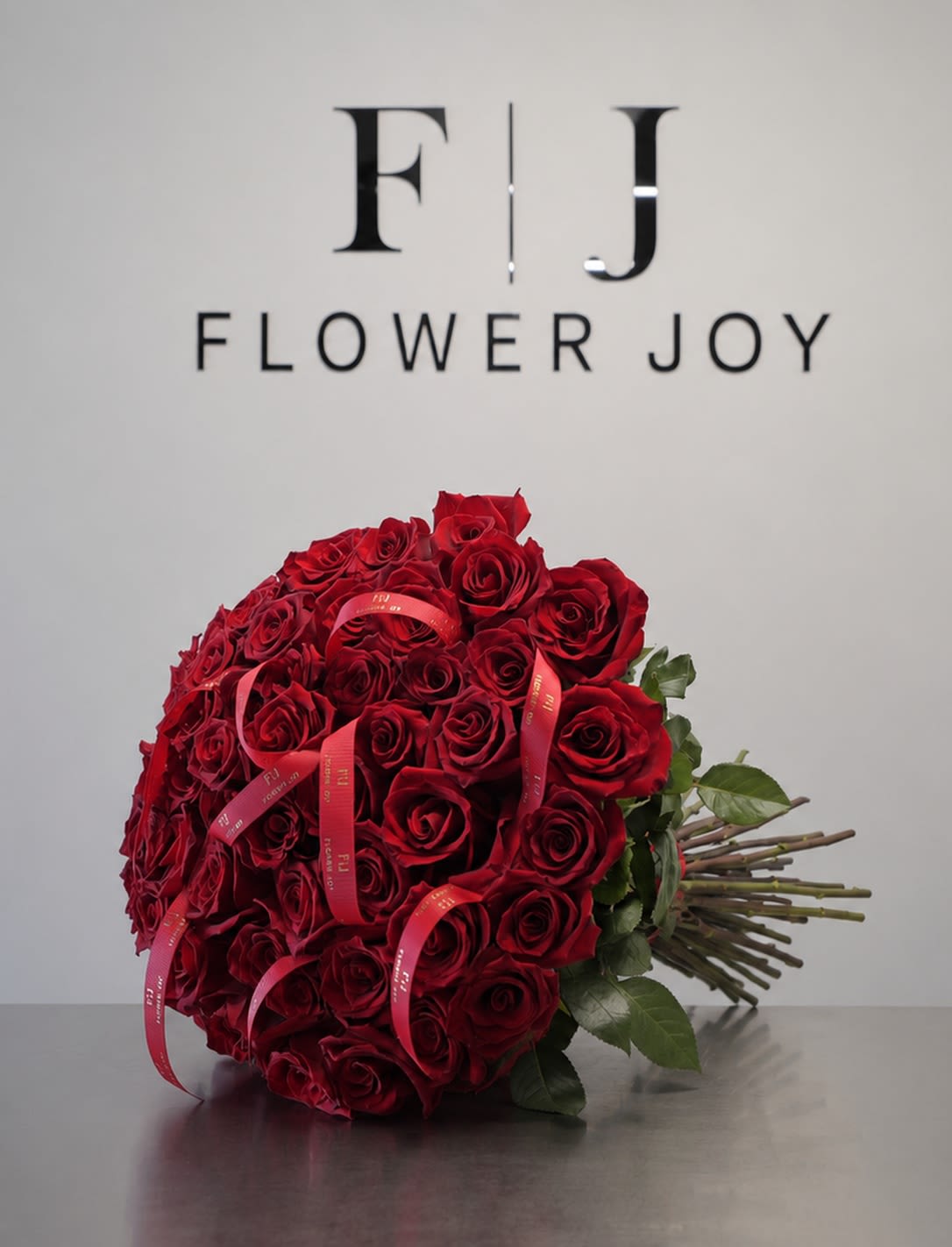 Classic Romance (50 Roses) - A stunning bouquet of 50 rich red roses, beautifully arranged with elegant ribbon details. A timeless symbol of love and passion, perfect for anniversaries, romantic surprises, or meaningful celebrations.
