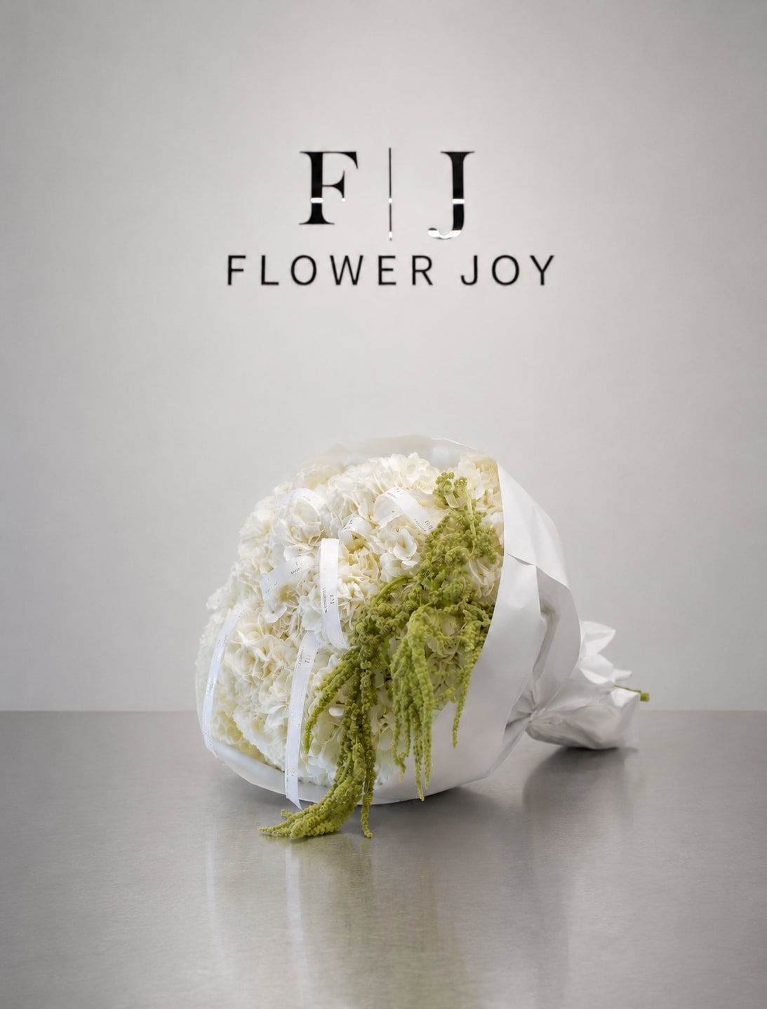 Ivory Cascade Bouquet - A graceful bouquet of lush white hydrangeas accented with cascading green amaranthus and elegant ribbon details, wrapped in crisp white paper. Fresh, modern, and refined, perfect for birthdays, congratulations, weddings, or sophisticated celebrations.