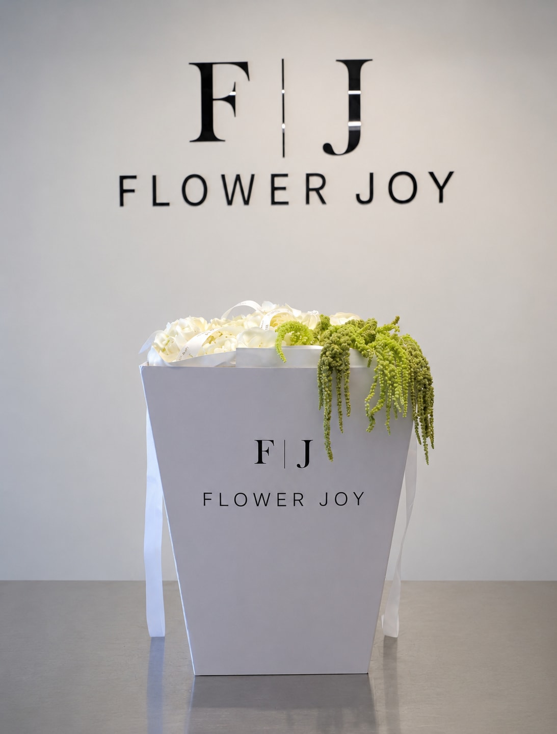 Ivory Cascade Gift Box - A refined arrangement of creamy white blooms accented with cascading green amaranthus, beautifully presented in a signature Flower Joy box. Modern, elegant, and distinctive, perfect for birthdays, congratulations, thank-you gifts, or sophisticated celebrations.