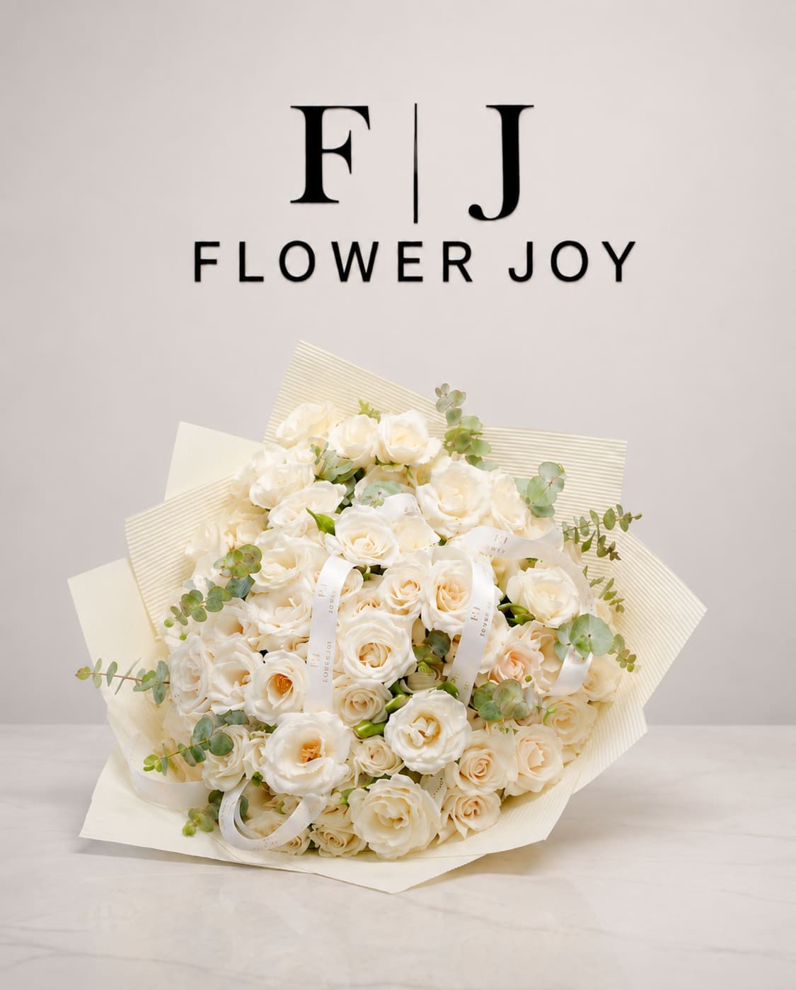 Bouquet of cream roses with eucalyptus accents and ribbon ties
