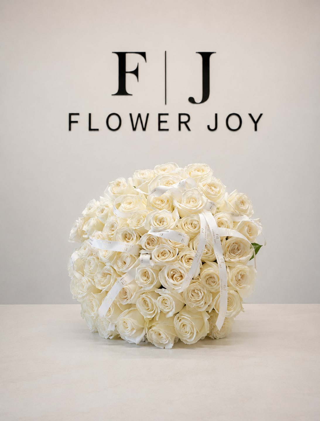 Timeless Grace (50 Roses) - A refined bouquet of 50 fresh white roses, beautifully arranged with delicate ribbon details. A classic expression of purity, admiration, and heartfelt love.