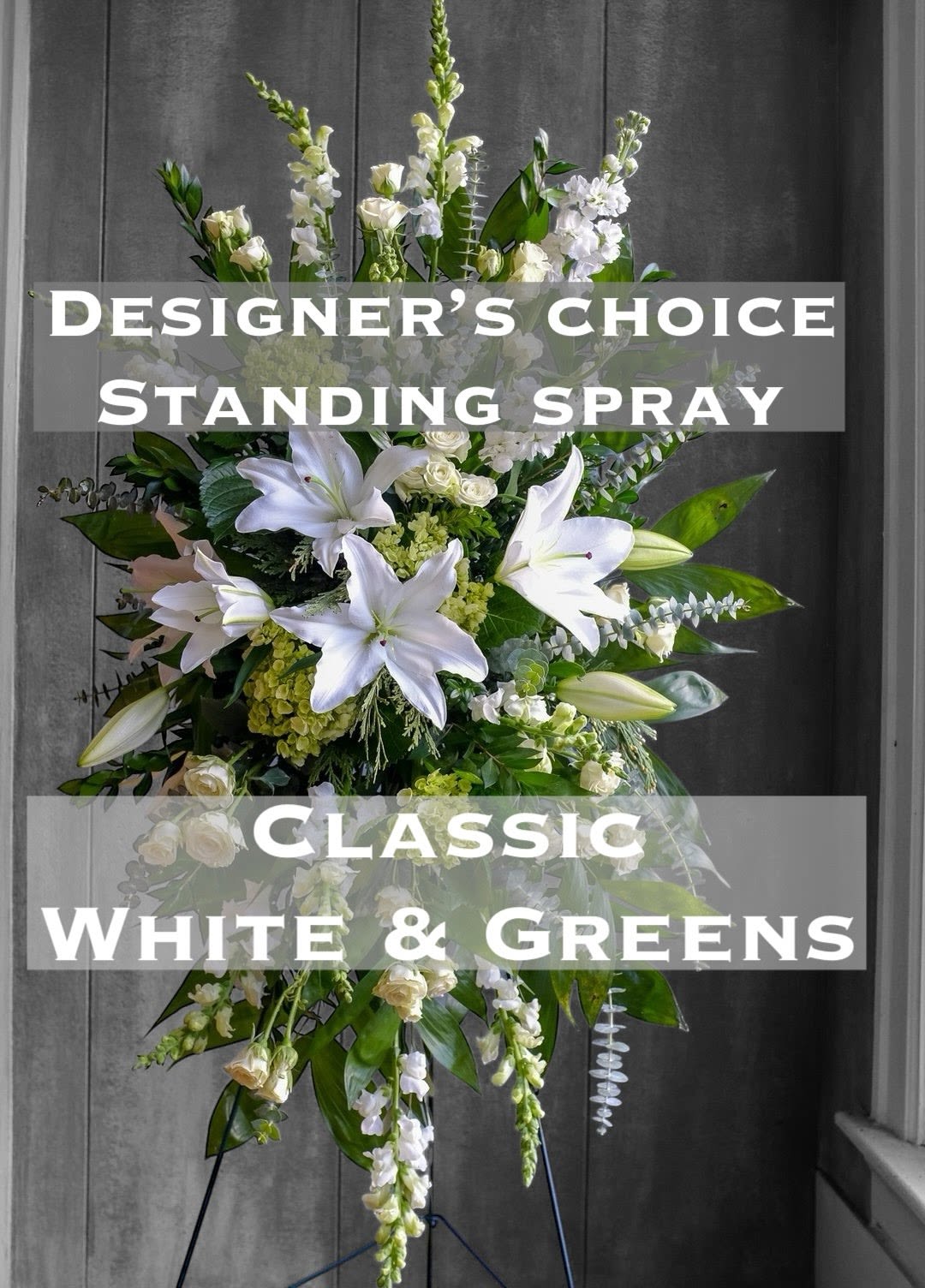 White and green standing spray with lilies and roses on a stand