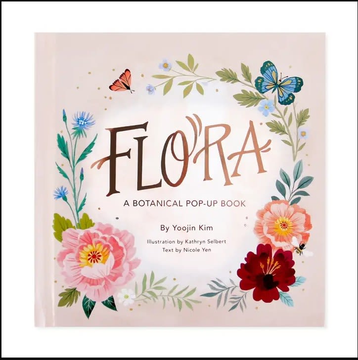 Botanical pop-up book cover with illustrated flowers and butterflies