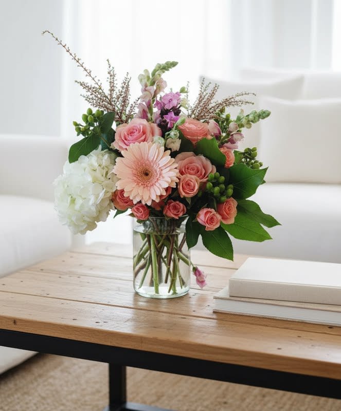 So Beautiful - The So Beautiful Bouquet has that fresh from the garden appeal that your special recipient will fall in love with! Peachy pink roses, pink gerbera daisies, green hydrangea, hypericum berries and an assortment of lush greens are brought together in a clear glass vase to create a delightful bouquet that is perfect to celebrate any of life's special moments. 