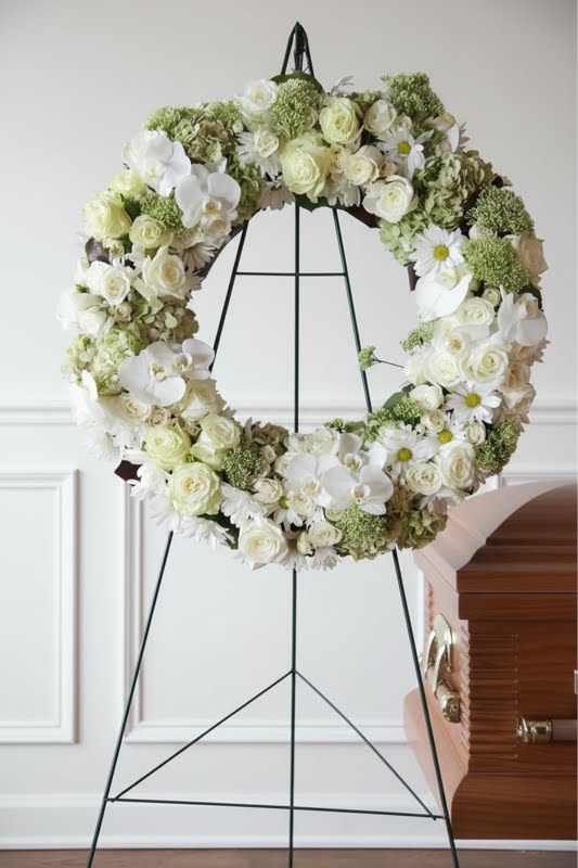 White Remembrance Sympathy Wreath - A lush gathering of premium flowers like roses, hydrangea and orchids... all in classic white and cream tones.  This 24 " wreath of fresh flowers on a 60" standing easel makes a memorable and stunning tribute for any loved one.