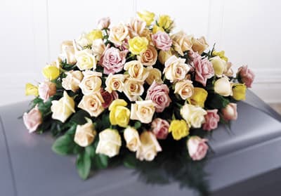 Large bouquet of pastel roses in cream, pink, and yellow