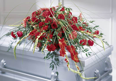 Red floral casket spray with roses and carnations