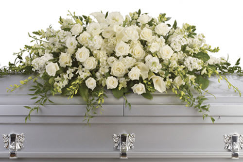 White rose and calla lily casket spray with cascading foliage on a silver casket