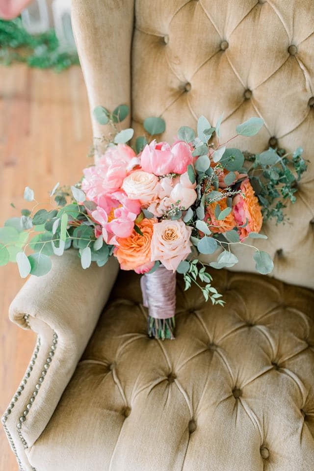 Pink and peach bouquet with eucalyptus on a chair