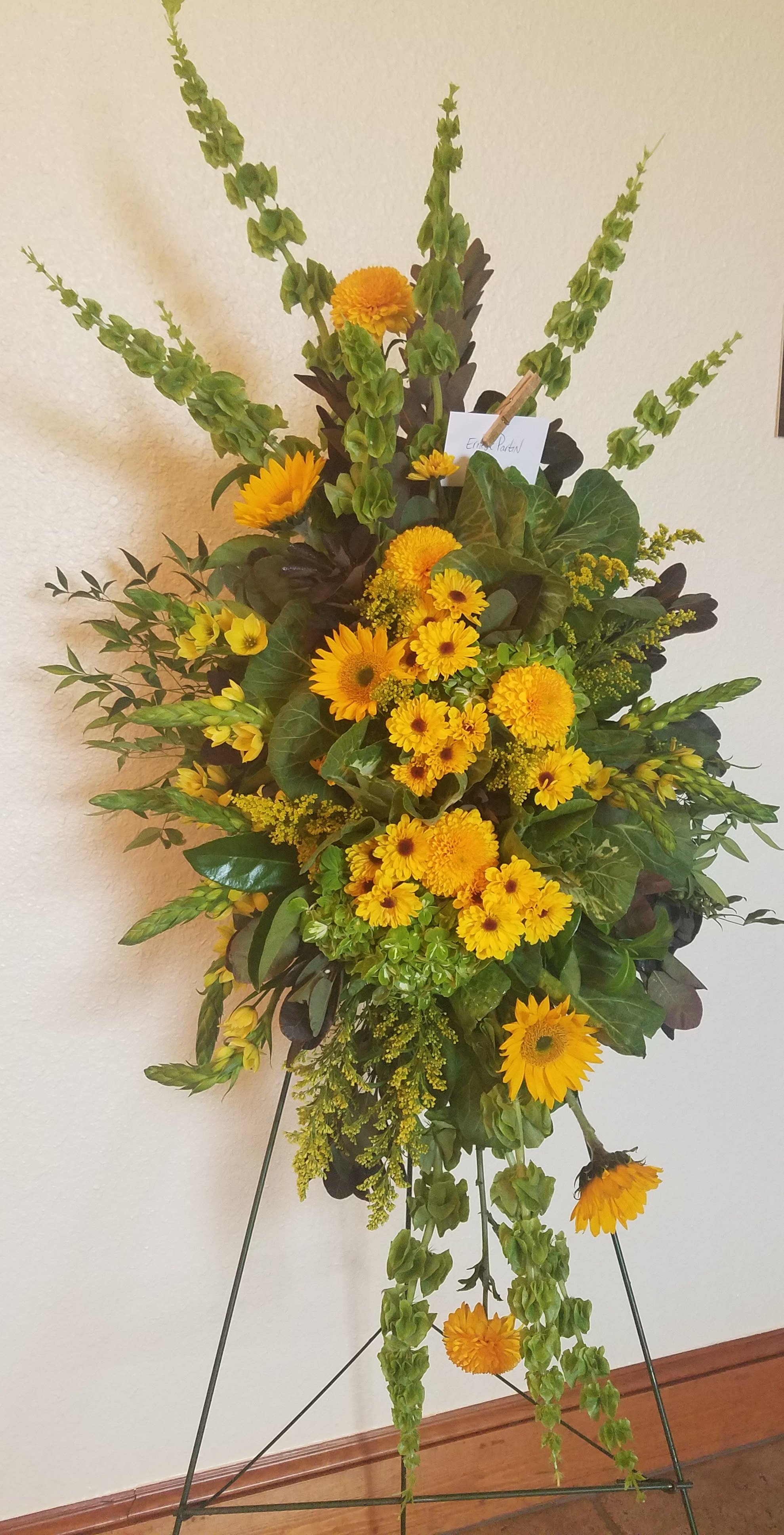 Tall yellow floral standing spray on an easel