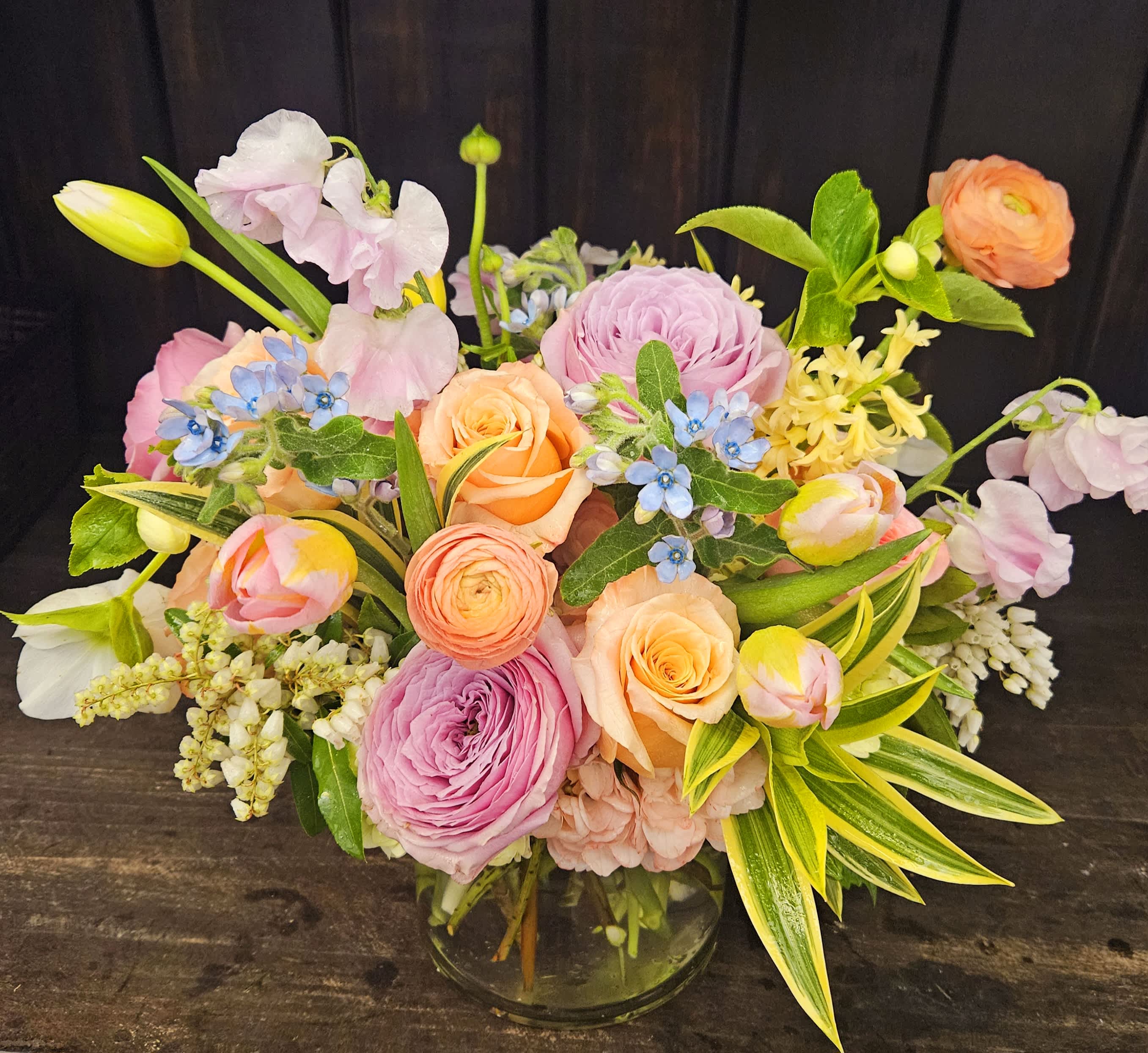 Garden Salon - A vibrant garden-style arrangement featuring premium seasonal blooms in a refined glass vessel.  Designed with movement and color, The Garden Salon brings the feeling of a fresh garden into the home.  Available exclusively from Camellia Farm Flora.  