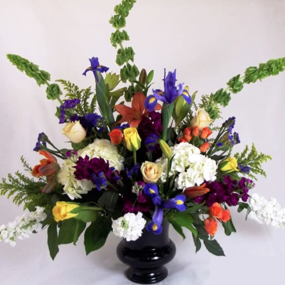 Colorful bouquet of mixed flowers in a black vase