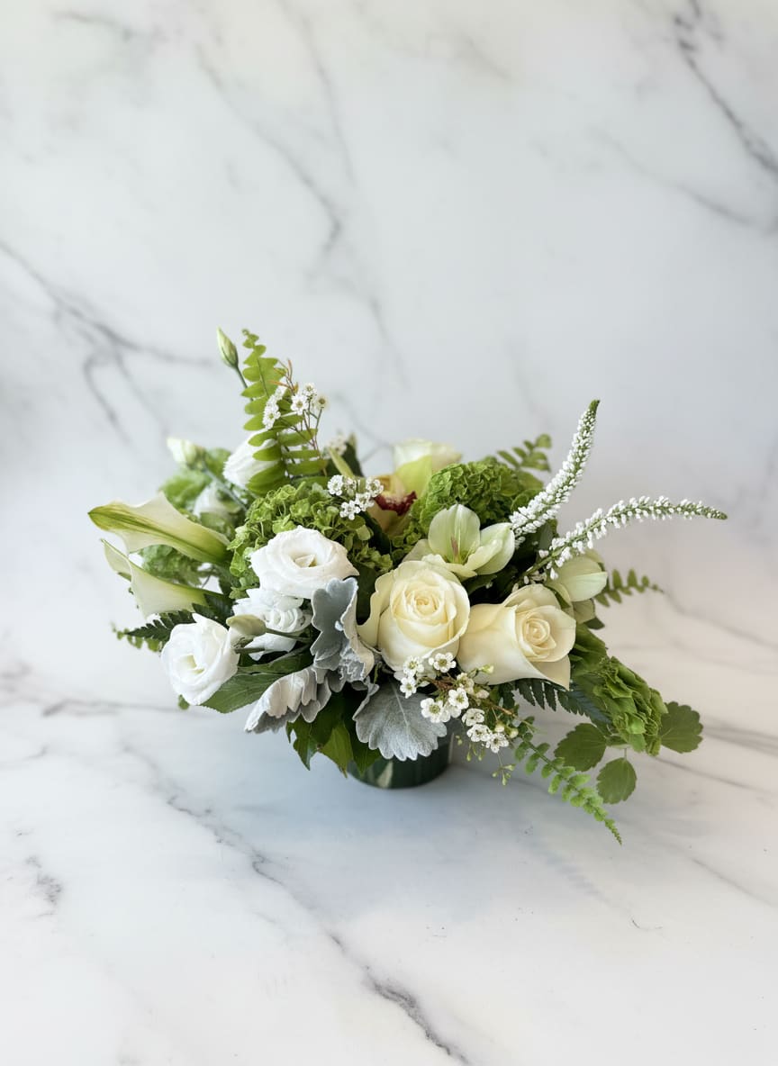 Verdant Joy  - Bright and full of charm, the verdant joy arrangement is a stunning blend of fresh blooms in vibrant greens.  Flowers include green hydrangea, creamy ivory roses, bells of Ireland and a kiss of a green cymbidium orchid.  This a a refreshing pick-me-up! 