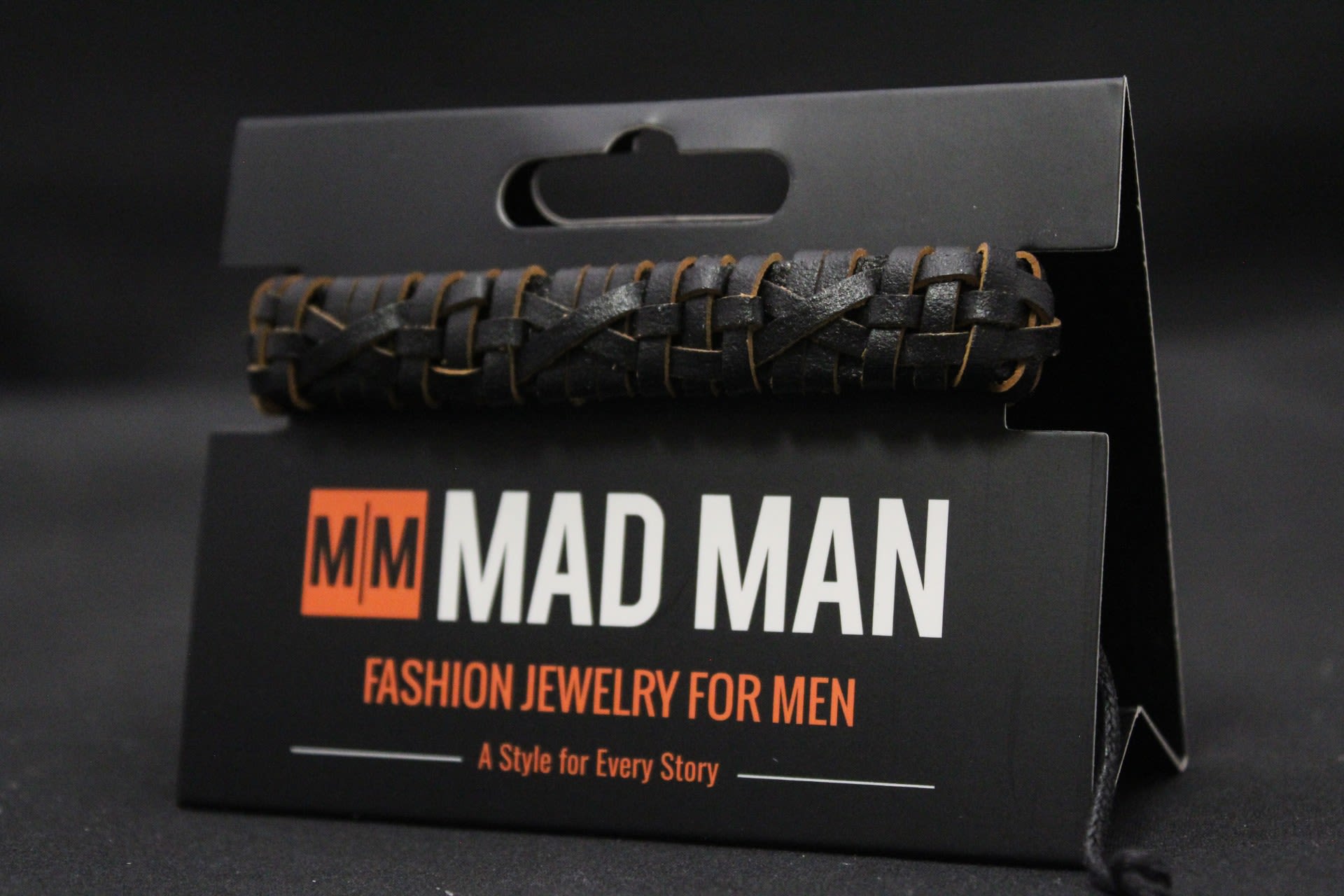 Men's Mad Man Leather Bacelet - Montana - A bold, tactile gift that reads rugged and modern - this braided leather bracelet is a stylish add-on for gift-giving and casual occasions. As a men's accessory for birthdays, Father's Day, or just-because presents.  The bracelet features a dark woven leather band with a basket-like braid and subtle brown undertones that catch the light against its matte finish. It includes an adjustable cord closure for a comfortable fit.  The wearer receives a compact, handcrafted-feeling accessory that pairs well with casual or outdoorsy styles.  Perfect as a thoughtful add-on to a bouquet or as a stand-alone small gift for the person you're thinking of, this bracelet offers an earthy, masculine touch without fuss. The adjustable fit and durable braided construction make it easy to wear daily.