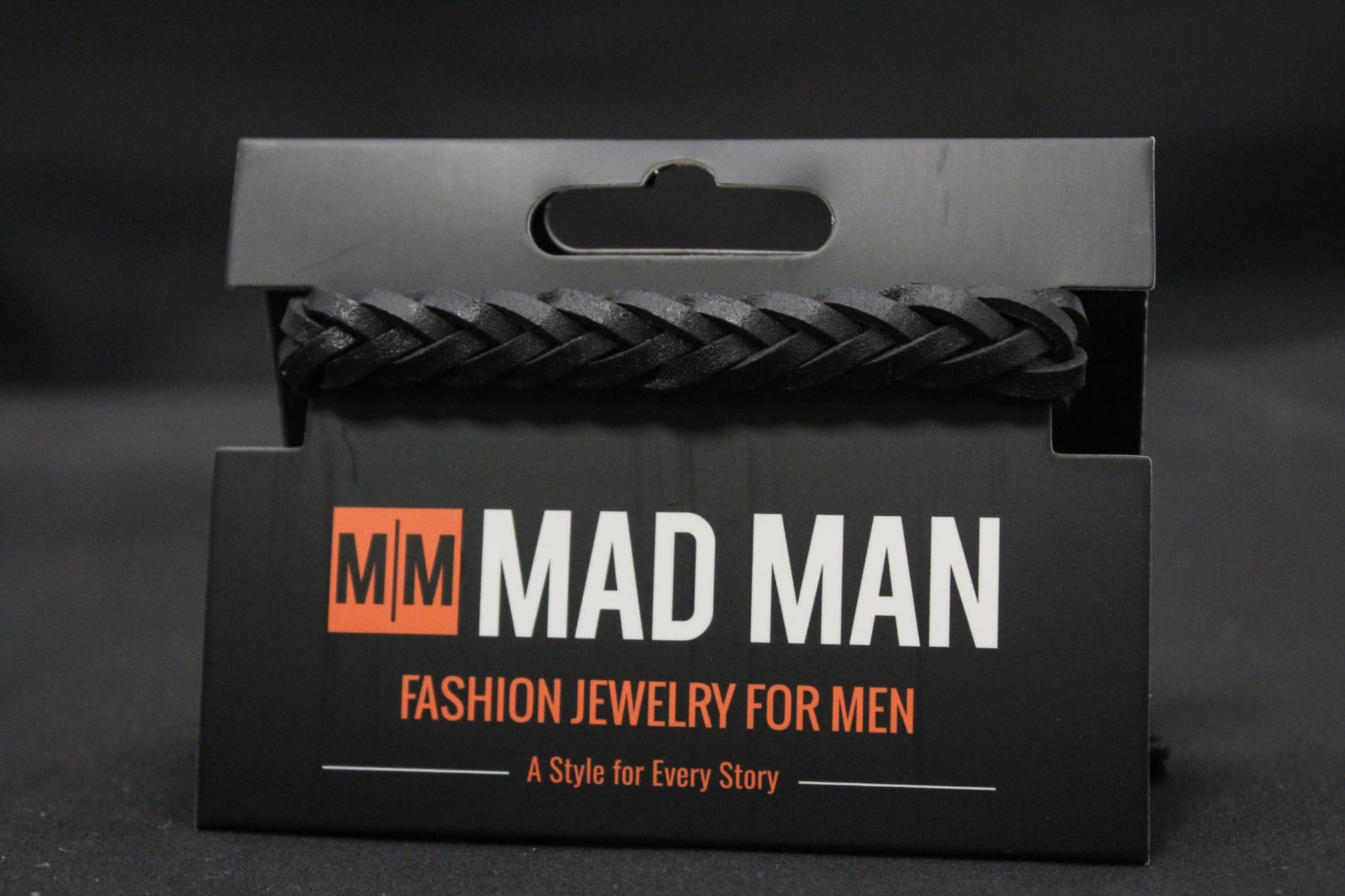 Men's Mad Man Leather Bracelet - Oakland - Chunky black braided leather gives this men's bracelet a bold, casual edge-perfect as a birthday, Father's Day, or "just because" gift for the guy who favors rugged everyday style. As a fashion accessory, it reads modern and masculine.  The band is a woven leather braid with a textured, substantial feel and an adjustable cord tie for a comfortable, custom fit. Small bead ends finish the cords and keep the closure neat.  Give this to the man who likes understated, wearable accessories-he'll feel seen for his personal style without fuss. Sizing is adjustable via the cord ties; order when you want a ready-to-wrap, low-maintenance gift that wears well every day.