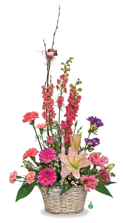 Pink and purple mixed flower arrangement in a woven basket