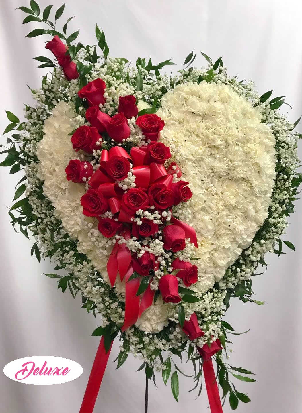 Heart-shaped floral spray with red roses and white flowers