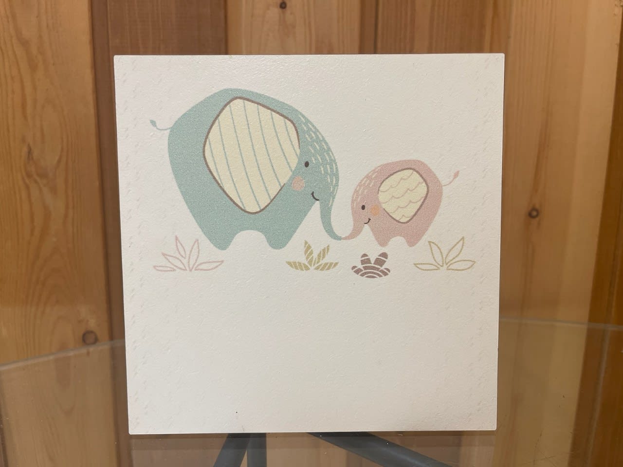 A card with two cartoon elephants touching trunks.