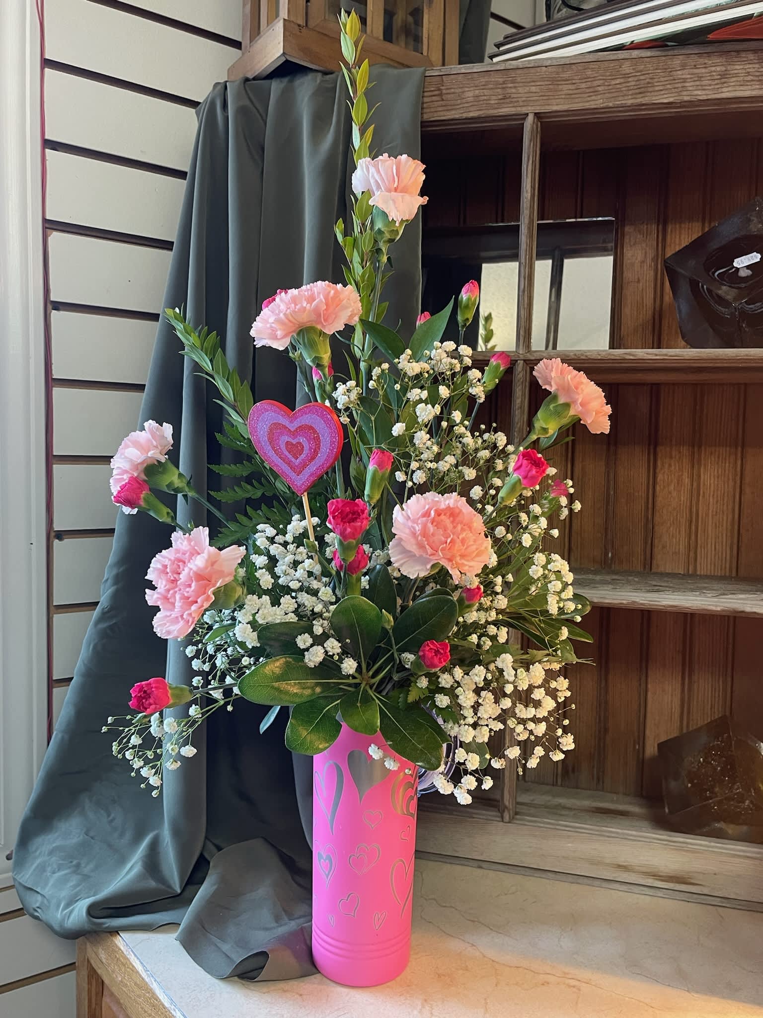 Pink carnations and baby's breath in a pink heart vase